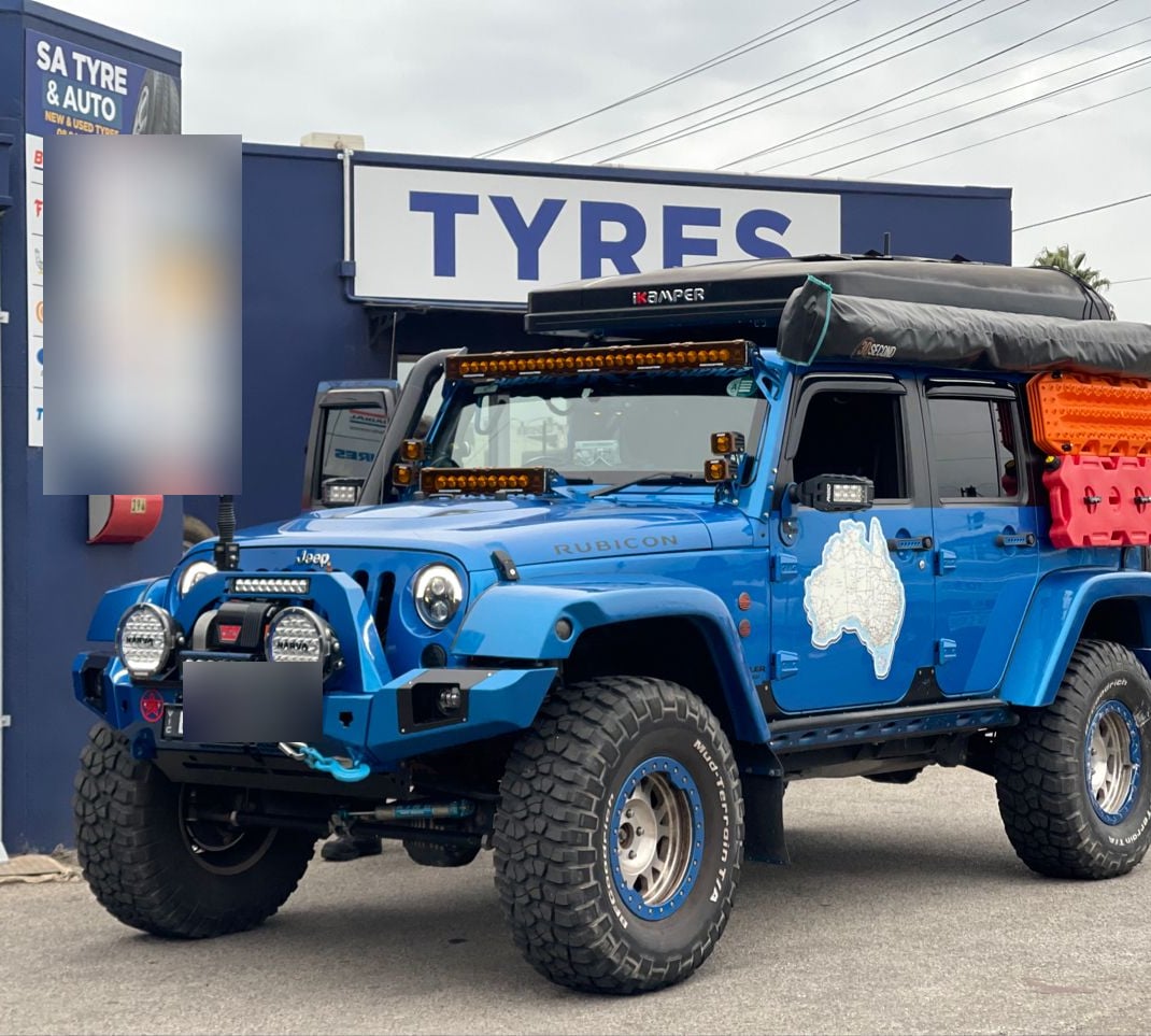 A customer 4WD parked out front of the shop, number plate and neighbouring signs blurred