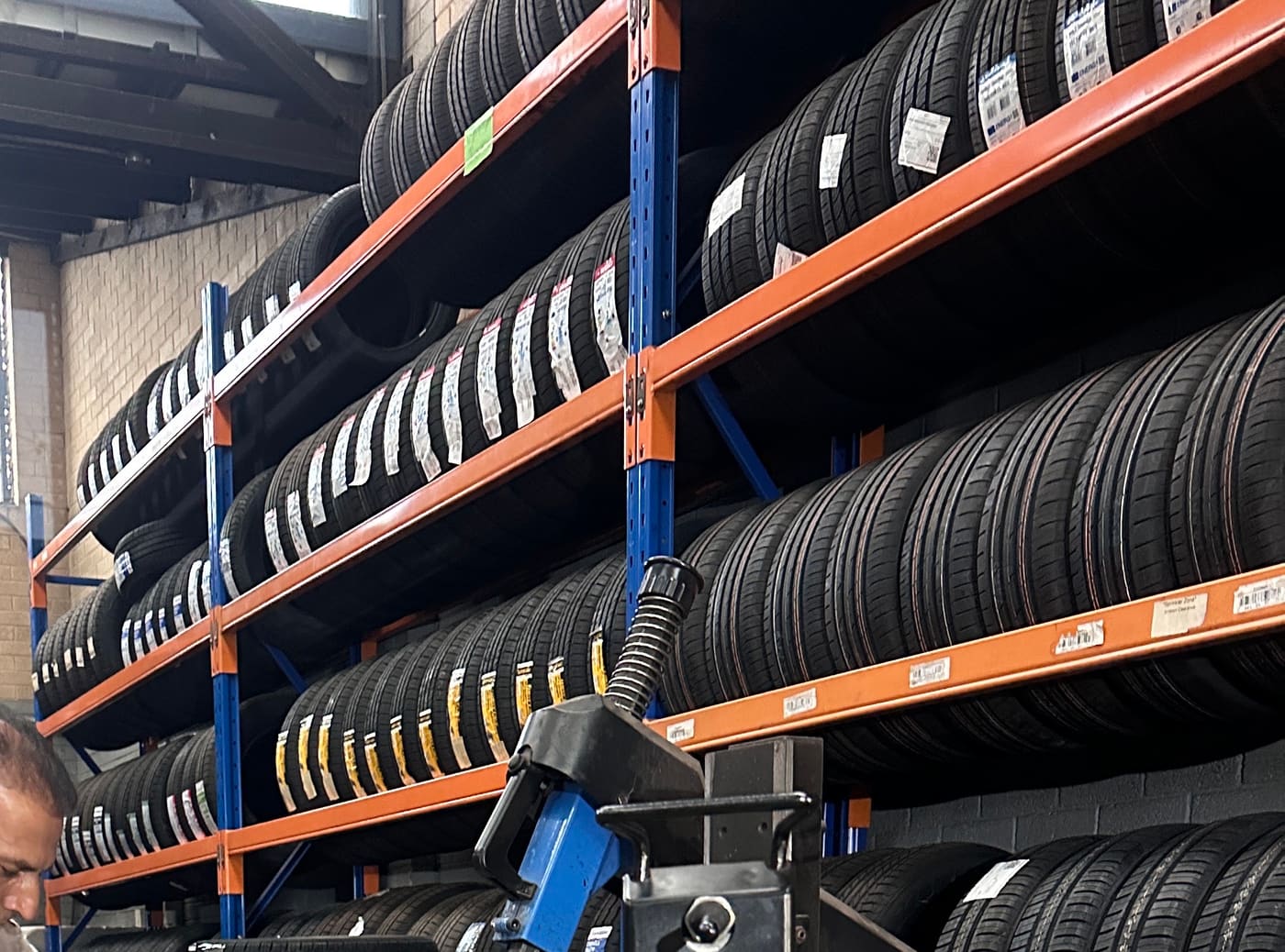 Racks of tyres along the workshop wall