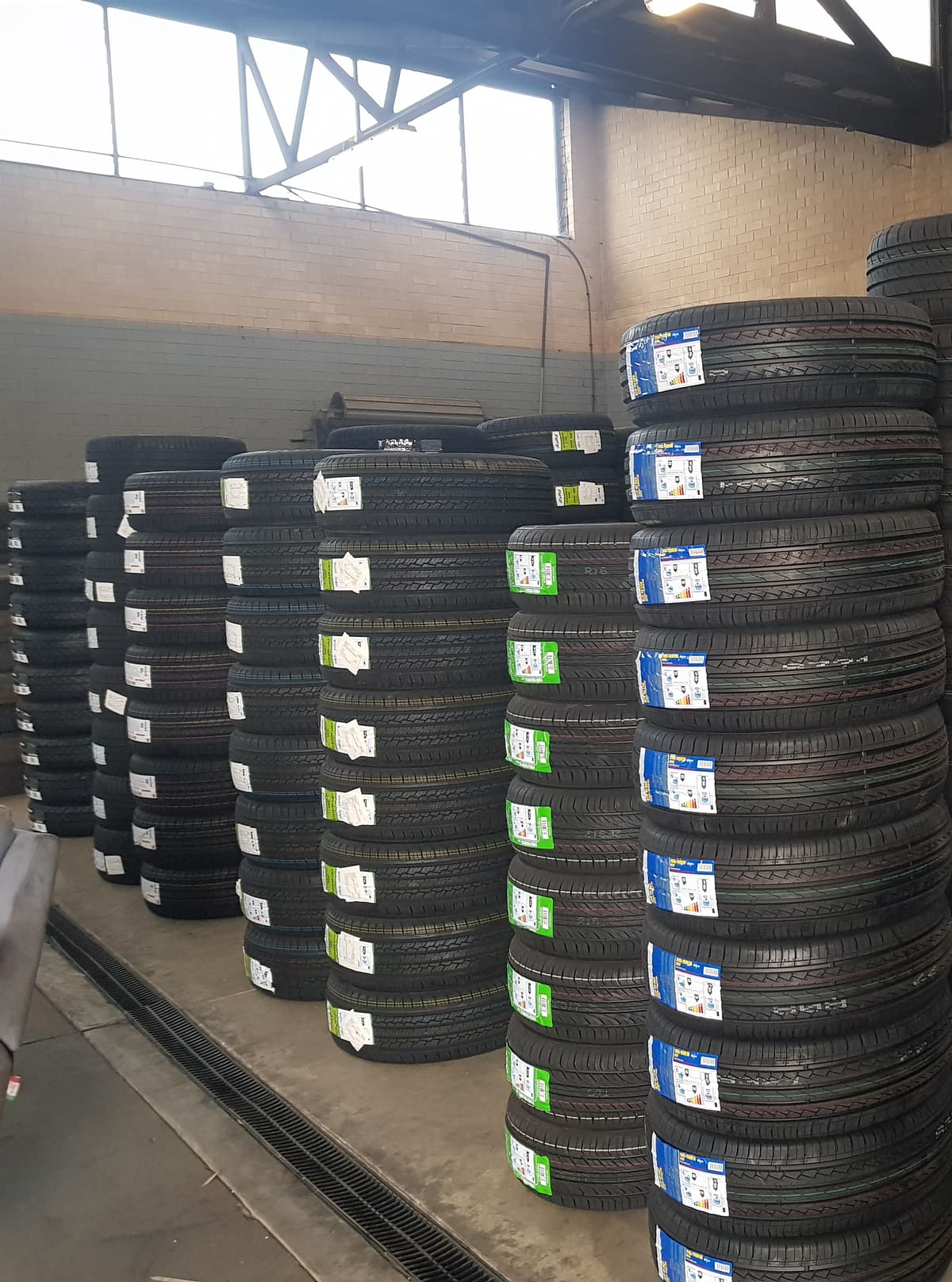 New tyres stacked in columns on the workshop floor